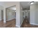 Long hallway with hardwood floors and access to other rooms at 19776 N Harris N Dr, Maricopa, AZ 85138