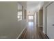Bright hallway with hardwood floors and views into other rooms at 19776 N Harris N Dr, Maricopa, AZ 85138