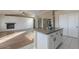 Open concept kitchen with island, hardwood floors, and a view into the living room at 19776 N Harris N Dr, Maricopa, AZ 85138