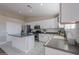 Modern kitchen featuring a center island, white cabinetry, and stainless steel appliances at 19776 N Harris N Dr, Maricopa, AZ 85138
