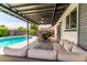 Covered patio with outdoor dining area and lounge seating beside the pool at 2041 E Harvard Dr, Tempe, AZ 85283