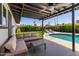 Covered patio with seating area, pool, and lush landscaping at 2041 E Harvard Dr, Tempe, AZ 85283