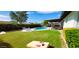 Spacious backyard with a pool, covered patio, lush lawn, and games at 2041 E Harvard Dr, Tempe, AZ 85283