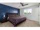 Modern bedroom with a king-size bed, stylish accent wall, and ceiling fan at 2041 E Harvard Dr, Tempe, AZ 85283