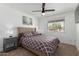 Comfortable bedroom with a queen bed, ceiling fan, and soft carpeting at 2041 E Harvard Dr, Tempe, AZ 85283