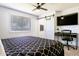 Bedroom with a king-size bed, a ceiling fan, a workspace, and sliding barn door at 2041 E Harvard Dr, Tempe, AZ 85283