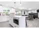 Open-concept kitchen and dining area with white cabinets, a large island, and modern appliances at 2041 E Harvard Dr, Tempe, AZ 85283