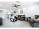Living room with plush seating, ceiling fan, and a view into the bright kitchen at 2041 E Harvard Dr, Tempe, AZ 85283
