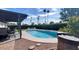 Inviting pool with a covered patio, lush landscaping, and a fire pit at 2041 E Harvard Dr, Tempe, AZ 85283