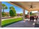 Relaxing backyard patio with seating area and grassy lawn at 21385 N Cloudcroft Ln, Surprise, AZ 85387