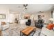 Open concept living room and kitchen with tiled floor and ceiling fans at 21385 N Cloudcroft Ln, Surprise, AZ 85387