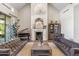 Living room with a chevron-patterned fireplace, a large mirror, and stylish furnishings at 24401 N 97Th Dr, Peoria, AZ 85383