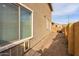 Exterior view of the side of the house with a gravel area and block wall at 25847 W Ripple Rd, Buckeye, AZ 85326