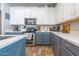 Modern kitchen with two-tone cabinets, stainless steel appliances, and tile floor at 25847 W Ripple Rd, Buckeye, AZ 85326