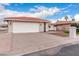 Inviting single-story home with a tile roof, attached two-car garage, and paved driveway at 26201 S Sherbrook Dr, Sun Lakes, AZ 85248