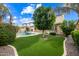 Lush backyard featuring a pool, green lawn, mature trees, and shrubs at 2872 E Redwood Pl, Chandler, AZ 85286