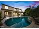 Backyard with pool, spa, and covered patio illuminated at dusk at 2872 E Redwood Pl, Chandler, AZ 85286