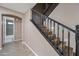 View of the wooden staircase with black railing and a glimpse of a bathroom at 2872 E Redwood Pl, Chandler, AZ 85286