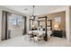 Main bedroom with a four-poster bed, two accent chairs, and plush carpeting at 2972 N 200Th Ave, Buckeye, AZ 85396