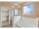 Primary bathroom featuring a soaking tub, walk-in shower, and walk-in closet at 2981 E Fandango Dr, Gilbert, AZ 85298