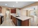 Kitchen featuring an island with white countertops, dark wood cabinets, and stainless steel appliances at 2981 E Fandango Dr, Gilbert, AZ 85298