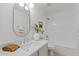 Clean and modern bathroom with white tile, a single vanity, and a bathtub at 3112 W Pleasant Ln, Phoenix, AZ 85041