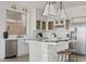 Stylish kitchen featuring white shaker cabinets, stainless steel appliances, and a brick backsplash at 3112 W Pleasant Ln, Phoenix, AZ 85041