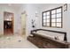 Modern bathroom featuring a soaking tub, glass shower, and tile flooring at 33296 N Vanishing Trl, Scottsdale, AZ 85266