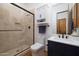 Modern bathroom with tiled shower, navy vanity, and white countertop at 33296 N Vanishing Trl, Scottsdale, AZ 85266