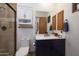 Bathroom featuring a walk-in shower, dark blue vanity, and white countertop at 33296 N Vanishing Trl, Scottsdale, AZ 85266