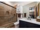 Modern bathroom with walk-in shower, dark blue vanity, and white countertop at 33296 N Vanishing Trl, Scottsdale, AZ 85266