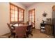 Breakfast nook with a wooden table, leather chairs, and wood blinds at 33296 N Vanishing Trl, Scottsdale, AZ 85266