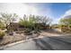 Exterior view of a home with desert landscaping and a circular driveway at 33296 N Vanishing Trl, Scottsdale, AZ 85266