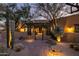 The entryway with a wooden pergola, desert plants, and walkway lighting at 33296 N Vanishing Trl, Scottsdale, AZ 85266