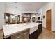 Kitchen with a large island featuring a farmhouse sink and light countertops at 33296 N Vanishing Trl, Scottsdale, AZ 85266