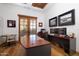 Home office with curved desk, wood floors, and French doors at 33296 N Vanishing Trl, Scottsdale, AZ 85266