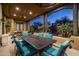 Covered patio with dining area and views of the pool and desert landscape at 33296 N Vanishing Trl, Scottsdale, AZ 85266