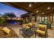 Comfortable outdoor seating area next to a pool and desert landscaping at 33296 N Vanishing Trl, Scottsdale, AZ 85266