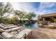 Backyard pool area with lounge chairs, a spa, and desert landscaping at 33296 N Vanishing Trl, Scottsdale, AZ 85266