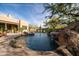 Inviting pool with a rock waterfall feature and surrounding patio at 33296 N Vanishing Trl, Scottsdale, AZ 85266