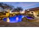Tranquil pool and spa with a rock waterfall feature and scenic sunset views at 33296 N Vanishing Trl, Scottsdale, AZ 85266