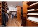 Large walk-in closet with built-in shelves, drawers, and hanging rods at 33296 N Vanishing Trl, Scottsdale, AZ 85266