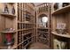 Custom-built wooden wine cellar with ample storage and display at 33296 N Vanishing Trl, Scottsdale, AZ 85266