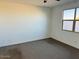 Empty bedroom with neutral walls and carpeting at 40310 W Hillman Dr, Maricopa, AZ 85138