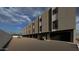 View of the apartment building with garages, balconies and a parked car at 4220 N 32Nd St # 36, Phoenix, AZ 85018