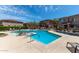 Community pool with lounge chairs and desert landscaping at The Village at Anthem at 42424 N Gavilan Peak Pkwy # 10104, Anthem, AZ 85086