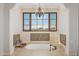 Luxurious bathroom with soaking tub, mountain views, and tile accents at 4308 N Sage Creek Cir, Mesa, AZ 85207