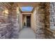 Welcoming entryway with stone accents, decorative iron security door, and an open-air ceiling at 4627 E Jude Ln, Gilbert, AZ 85298