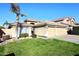 Inviting curb appeal with lush green lawn, palm tree, and three-car garage at 5104 E Libby St, Scottsdale, AZ 85254