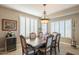 Elegant dining room with a large table, plantation shutters, and a wine cooler at 5252 W Posse Dr, Eloy, AZ 85131